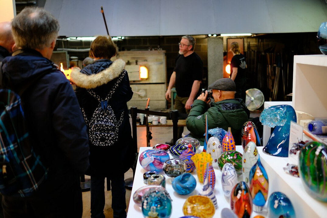 People collaborating around a table in a workshop