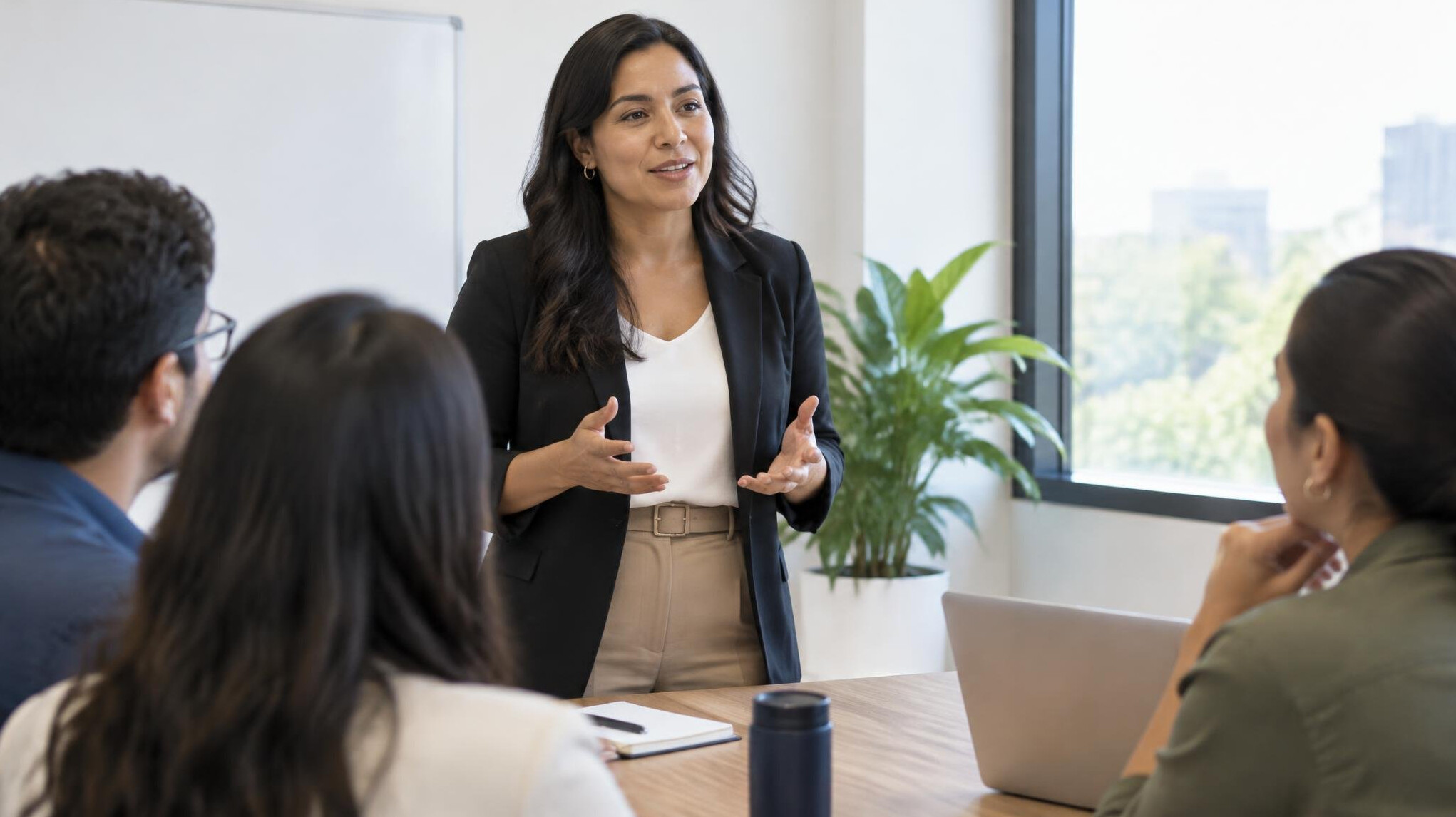Woman speaking to a small group during a meeting